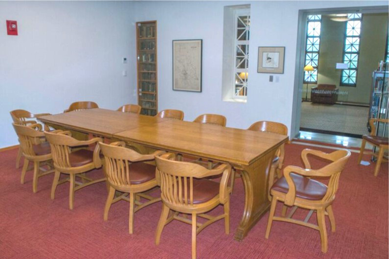 Boardroom with a rectangular conference table and eleven chairs