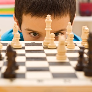 Child looking at chess board