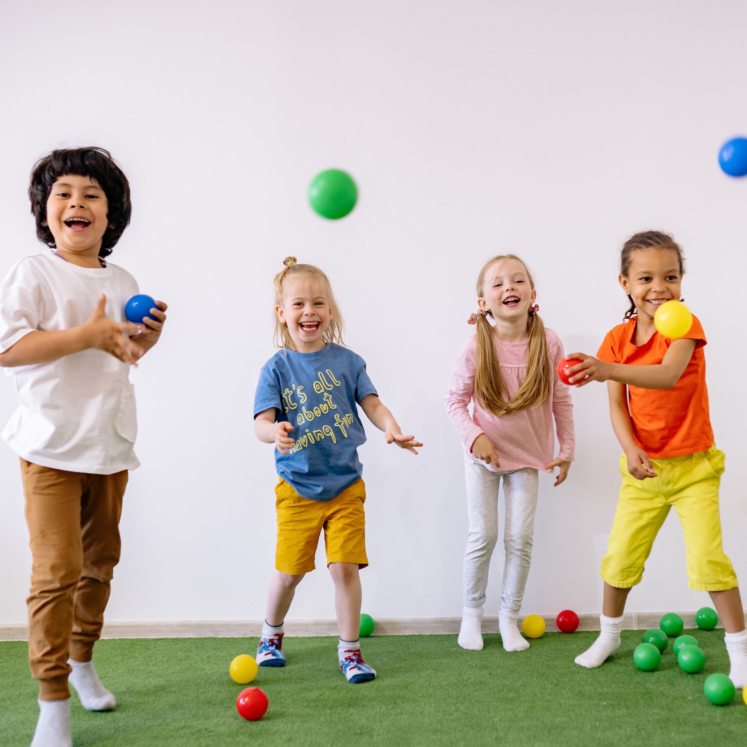 Photograph of kids playing with balls