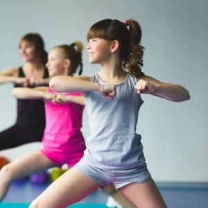 Photograph of three children in warrior yoga pose