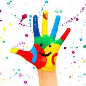 Painted hand with smiley face on paint splatter background