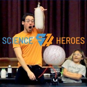 photograph of science heroes performer holding smoke-filled balloon
