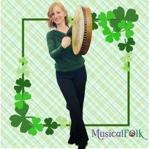 Photo of Liz McNicholl playing drum on green background with shamrocks