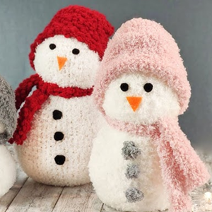 Two snowmen made from socks sit in the center of the image. They wear hats and scarves.