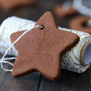 a brown star ornament against a roll of twine.